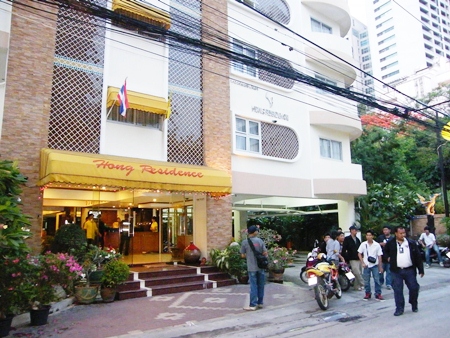 Residents gather outside the Hong Residence on Soi 4 after fearing there was a gas leak inside.